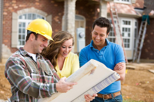 a couple consulting with the home building contractor about adding a generator during the construction process